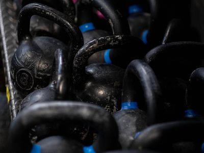 Close-up on equipment like a kettlebell in a minimalist setting.